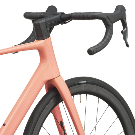 Peach pink Scott Addict 25 road bike from a front three-quarter angle with the SCOTT logo on the down tube.
