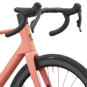Cockpit of the peach pink Scott Addict 25 with taped drop bars and SRAM Rival AXS shifters.