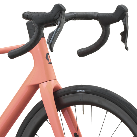 Cockpit of the peach pink Scott Addict 25 with taped drop bars and SRAM Rival AXS shifters.