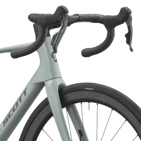 Cockpit of the iron grey Scott Addict 25 with taped drop bars and SRAM Rival AXS shifters.