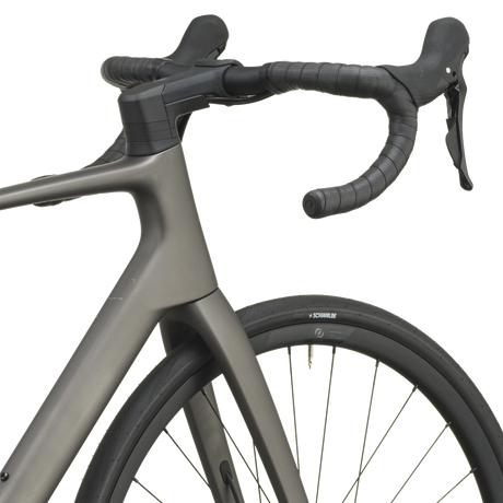 Tungsten grey Scott Addict 50 road bike from a front three-quarter angle with the SCOTT logo on the down tube.