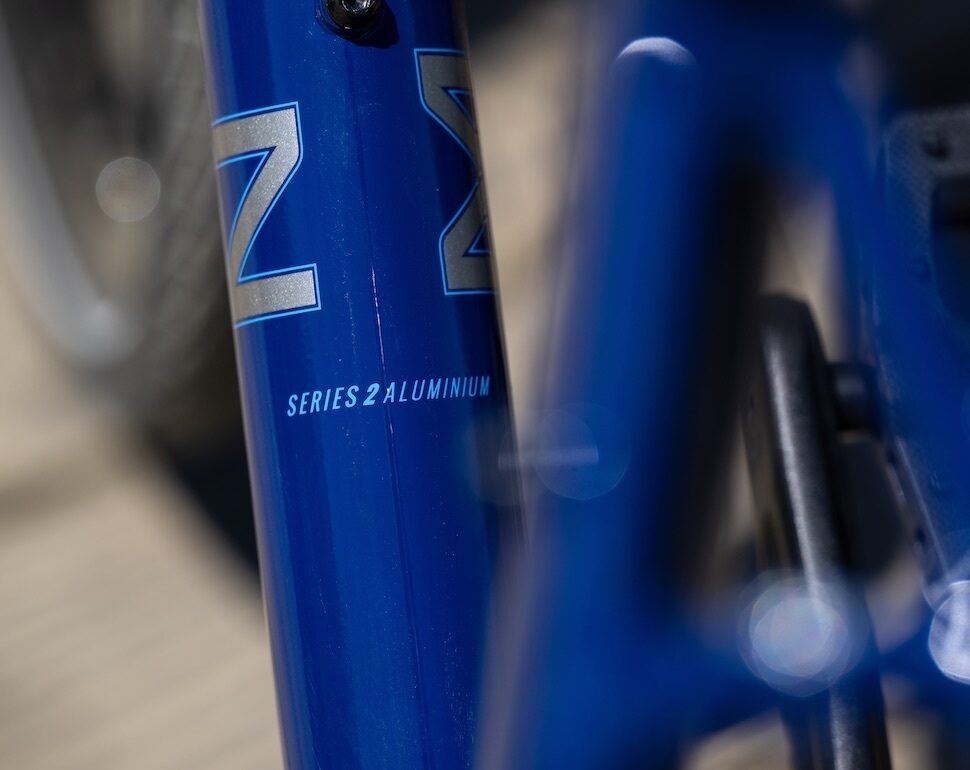 Close-up of a blue bicycle frame with 'Z' branding and 'Series 2 Aluminium' text.