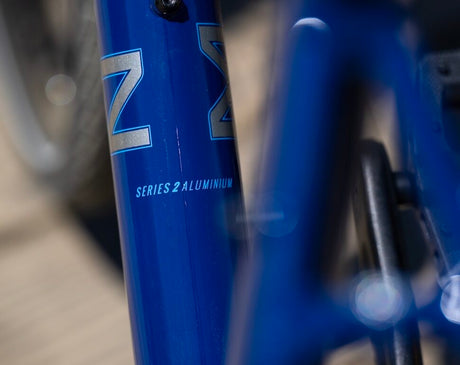 Close-up of a blue bicycle frame with 'Z' branding and 'Series 2 Aluminium' text.