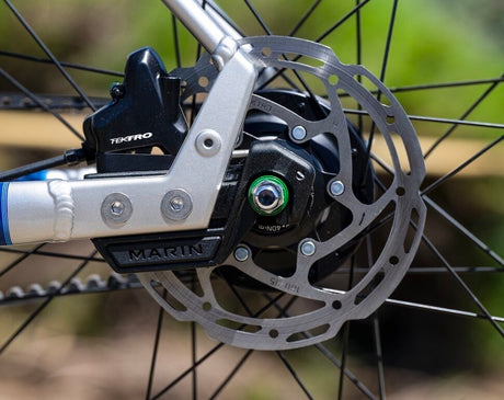 Close-up of a bicycle disc brake system with 'Marin' branding.