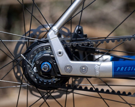Close-up of a bicycle chain and gear system with 'Presidio' branding.