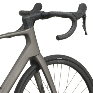 Tungsten grey Scott Addict 50 road bike from a front three-quarter angle with the SCOTT logo on the down tube.