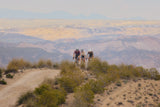 Distant riders on a ridge on Argon 18 Anti Matter gravel bikes, wide valley behind