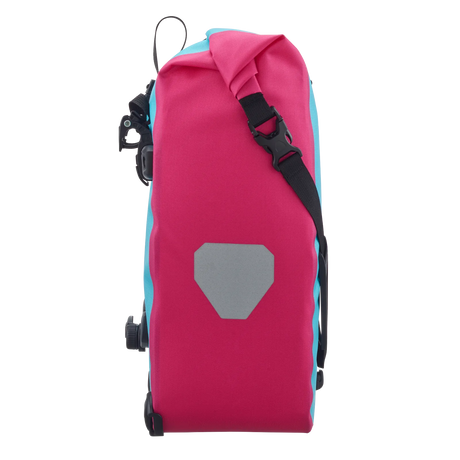 Cyber pink waterproof pannier bag with black strap and reflective gray patch on side.