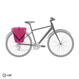 Cyber pink waterproof Ortlieb Back-Roller 20L pannier bag attached to rear rack of black bicycle.