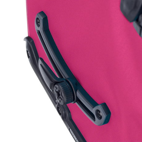 Close-up of the black mounting bracket and attachment knob on a cyber pink Ortlieb Back-Roller pannier bag.