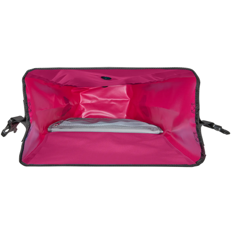 Open bright pink waterproof pannier bag showing spacious main compartment with mesh pocket inside.