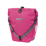 Cyber pink waterproof pannier bag with roll-top closure and black adjustable straps.
