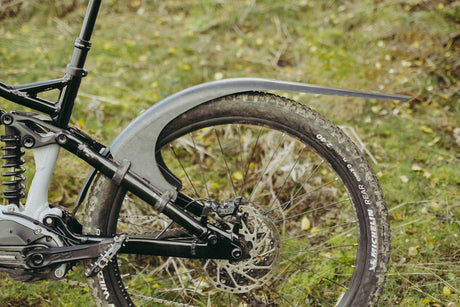 Mudhugger MK2 rear mudguard fitted to the seat stays of a full suspension mountain bike outdoors