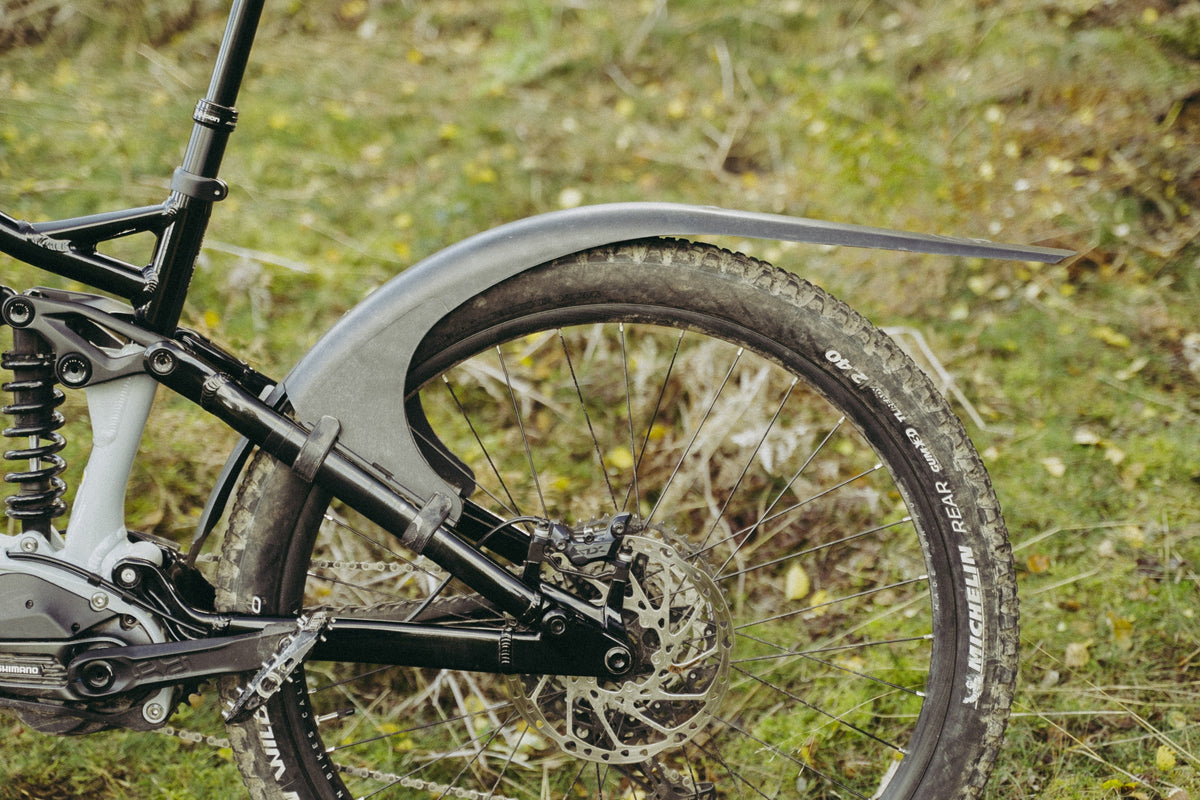 Mudhugger MK2 rear mudguard fitted to the seat stays of a full suspension mountain bike outdoors