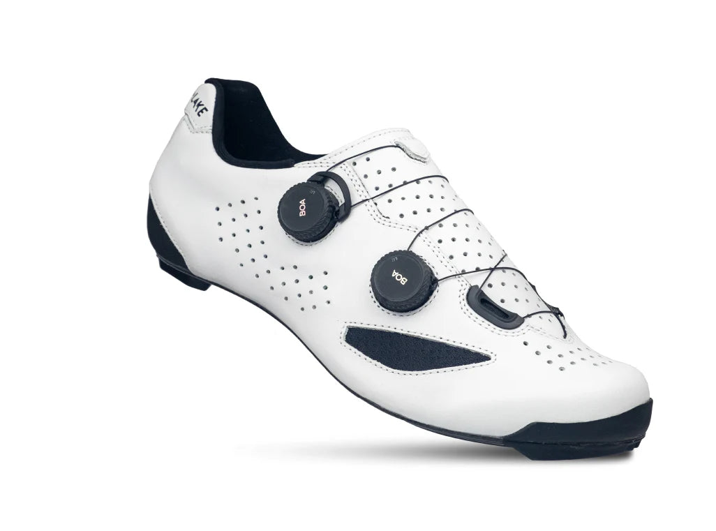 White cycling shoe with black accents on a white background