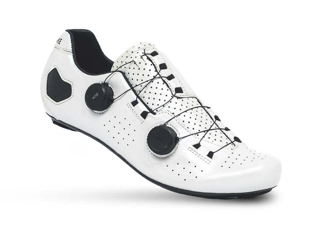 White cycling shoe with black accents on a white background