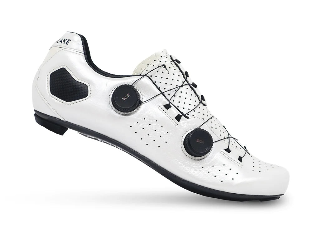 White cycling shoe with black accents on a white background