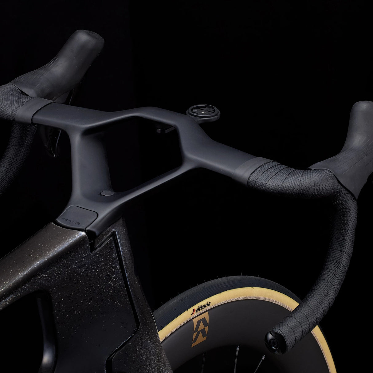 Detail of Cervélo S5 Dura-Ace Di2 integrated cockpit and aero handlebars in black, engineered for reduced drag and enhanced control on road rides.