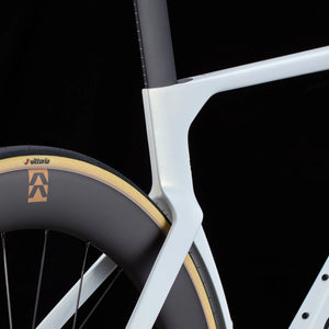 Close-up of white Cervélo S5 Dura-Ace Di2 Road Bike seat stay and rear wheel junction, showcasing aerodynamic frame design and Vittoria tire setup.