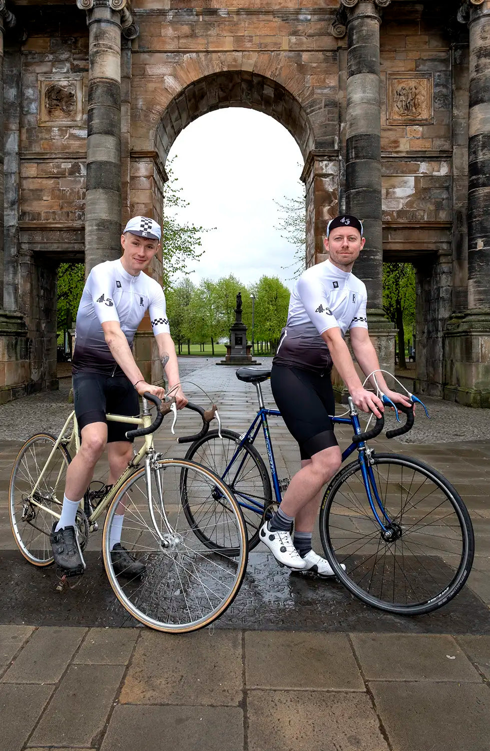 Cyclists pose with vintage bikes wearing the 45th Anniversary Short Sleeve Mens Jersey, celebrating Billy Bilsland Cycles' legacy in Glasgow.