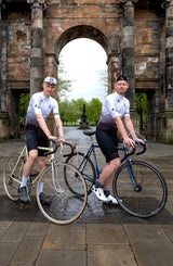 Cyclists pose with vintage bikes wearing the 45th Anniversary Short Sleeve Mens Jersey, celebrating Billy Bilsland Cycles' legacy in Glasgow.