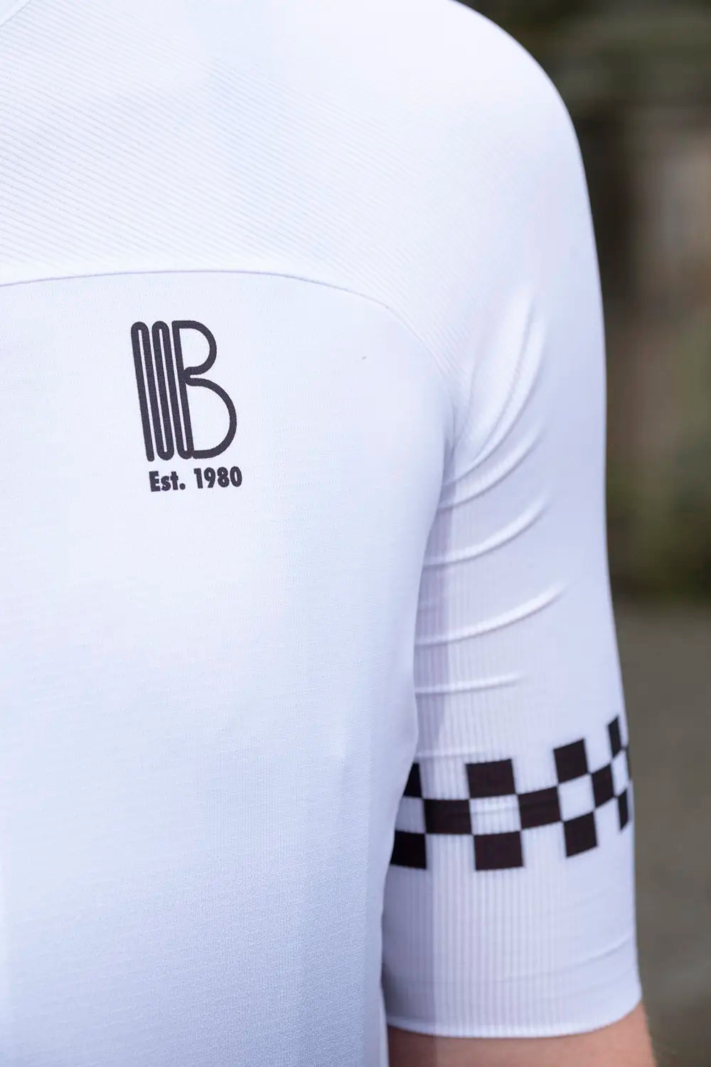 Close-up of the 45th Anniversary Short Sleeve Mens Jersey chest logo showing 'BB Est. 1980' in black on white fabric.