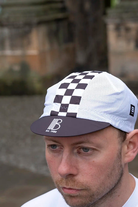45th Anniversary Mesh Cycling Cap featuring black and white checkered stripe and breathable mesh panels, ideal for road cycling enthusiasts.