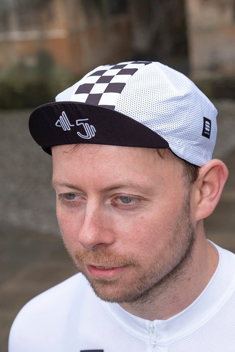 Limited edition 45th Anniversary Mesh Cycling Cap with retro checkered design and embroidered logo, perfect for commemorating cycling heritage.