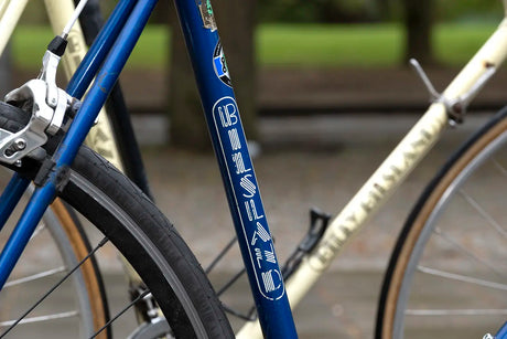 Billy Bilsland Cycles branding on a blue vintage bike frame, highlighting the shop's heritage in cycling culture.