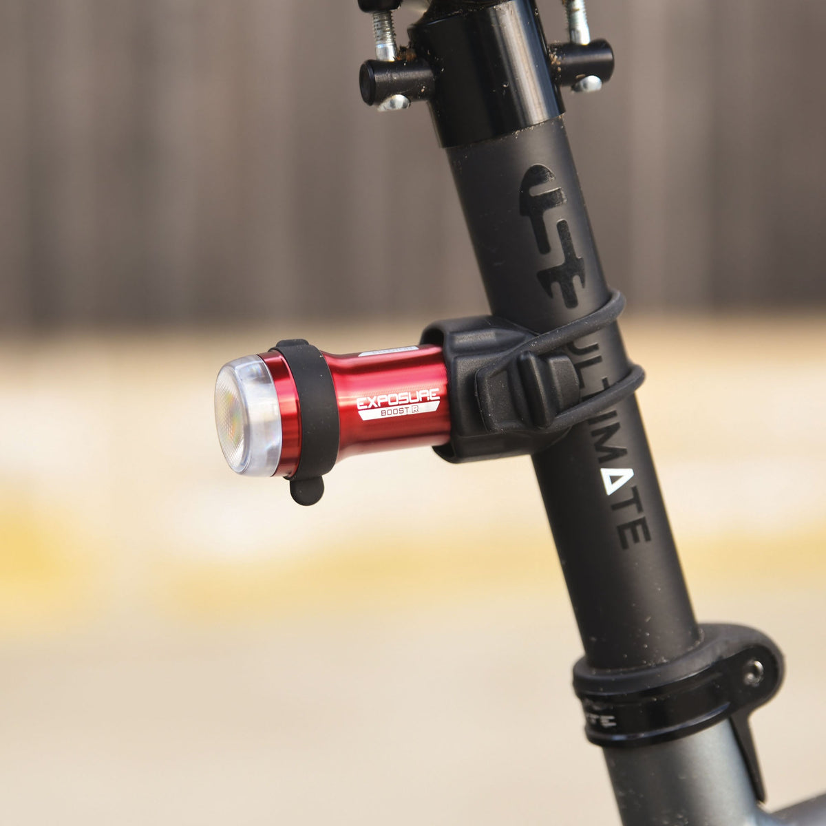 Exposure BoostR Mk3 rear light clamped to a seatpost, seen from the side