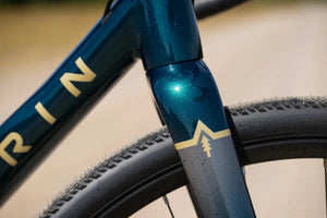 Down tube and carbon fork of the Marin Gestalt 1 in metallic teal, with gravel tyre alongside