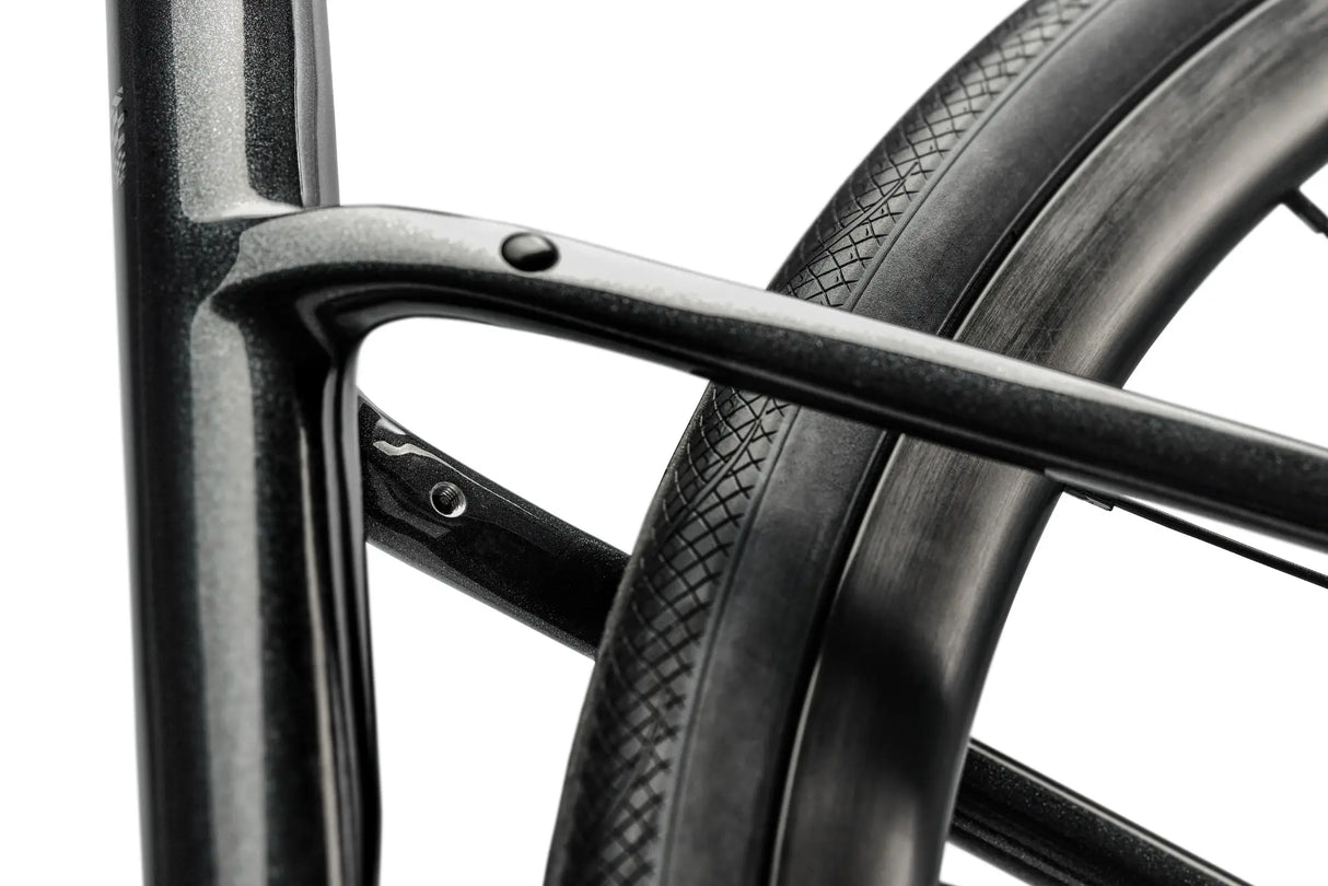 Close-up of a bicycle wheel with a black rim and tire on a white background