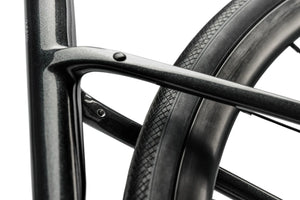 Close-up of a bicycle wheel with a black rim and tire on a white background