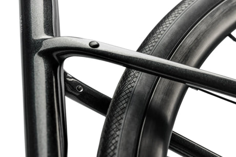 Close-up of a bicycle wheel with a black rim and tire on a white background