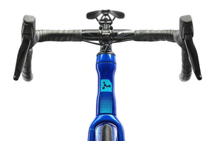Close-up of a bicycle handlebar with blue frame and black grips on a white background
