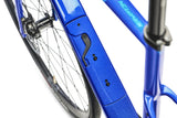Close-up of a blue bicycle frame with visible branding on a white background