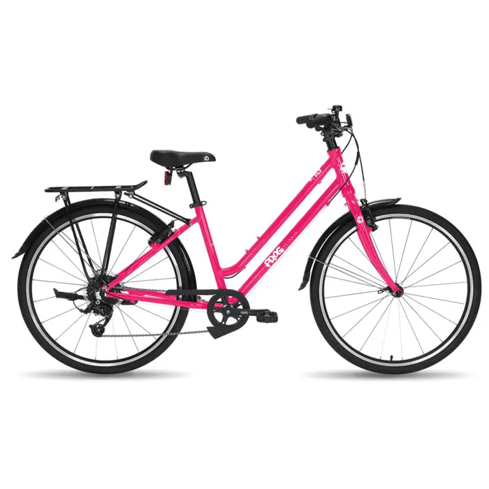 Introducing the Frog City 67 Kids Hybrid Bike: a vibrant pink city bicycle designed for urban adventures, featuring a step-through lightweight aluminum frame. This bike includes black saddle and handlebars, front and rear fenders, a rear rack, and a 7-speed gear system. It is showcased against a plain white background.