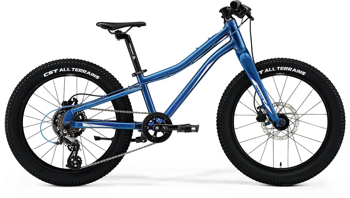 Merida Matts J.20+ Kids Hybrid Bike in metallic blue with fat 2.4-inch tires for superior grip and cushioning, designed for young riders.