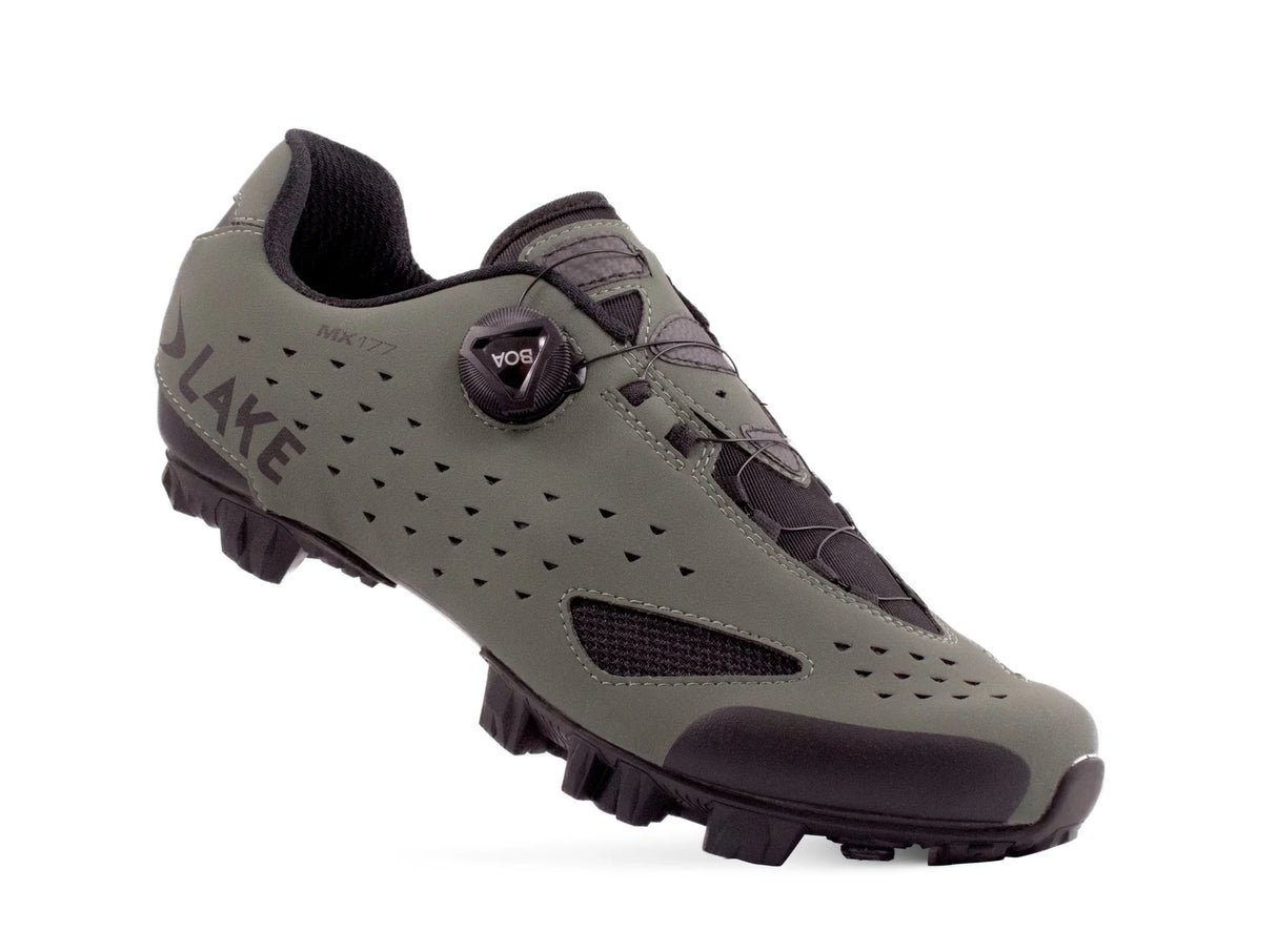 Gray cycling shoe with black sole on a white background