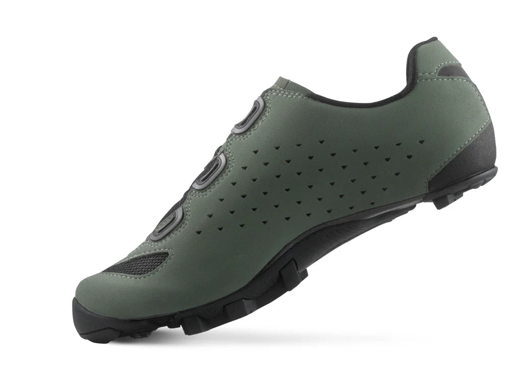 Green cycling shoe with black sole on a white background