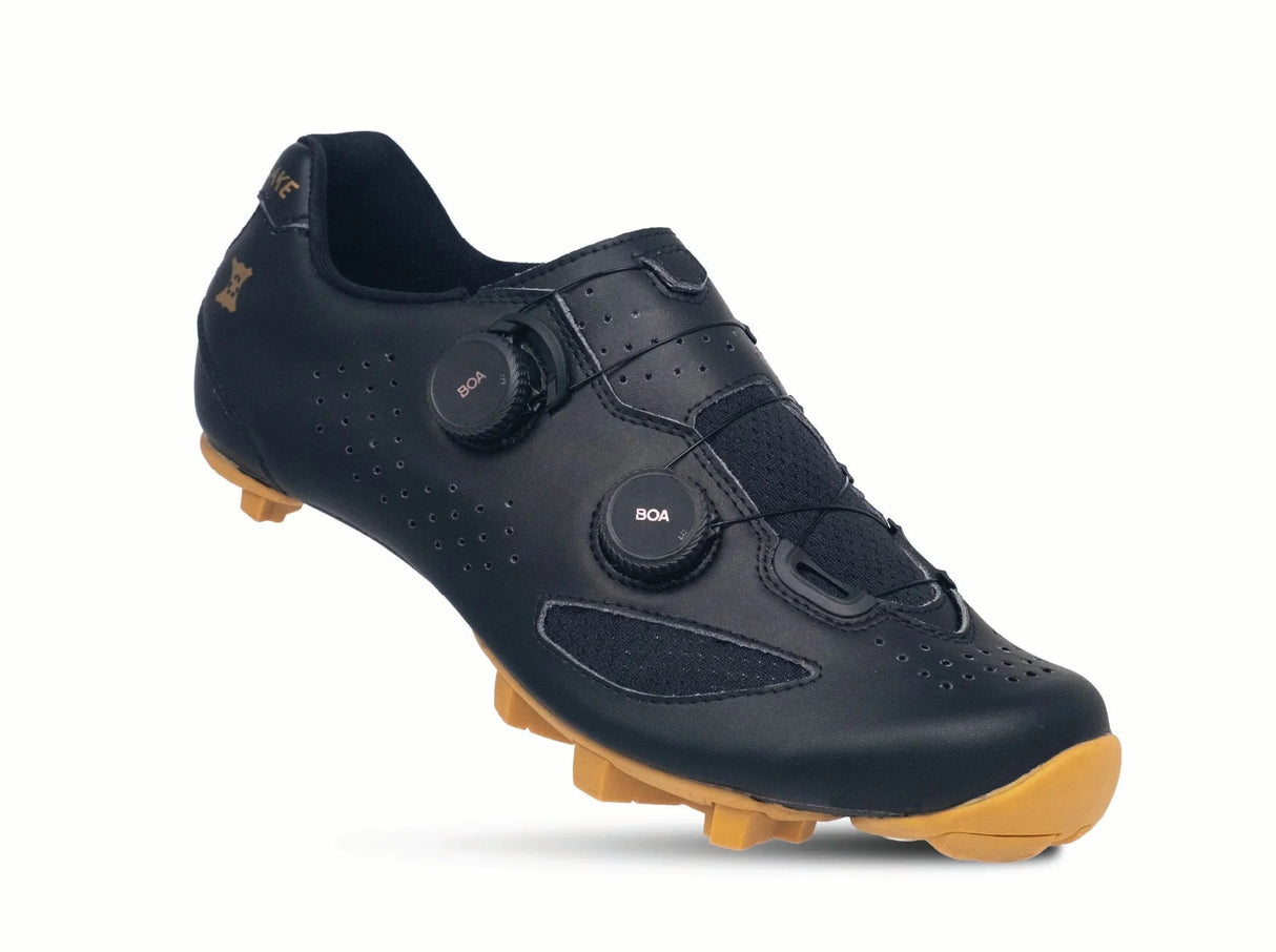 Black cycling shoe with brown sole on a white background