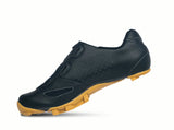 Black cycling shoe with yellow sole on a white background