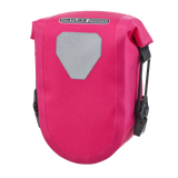 Compact cyber pink Ortlieb Micro-Bag saddle bag with reflective gray patch and black mounting clips.