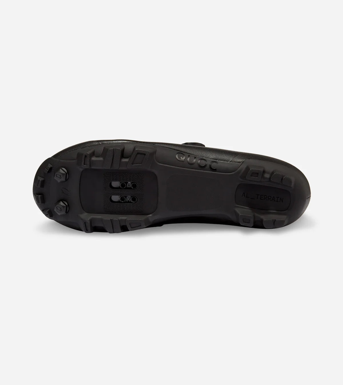Sole view of QUOC Escape Off-Road Shoe in black, featuring all-terrain tread and SPD cleat compatibility for trail use.