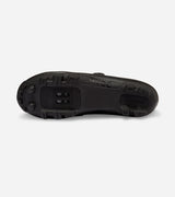 Sole view of QUOC Escape Off-Road Shoe in black, featuring all-terrain tread and SPD cleat compatibility for trail use.