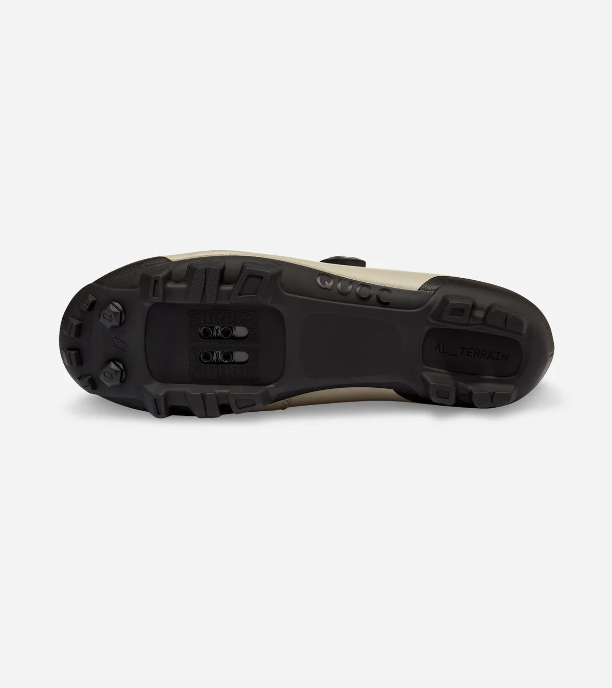 Sole of QUOC Escape Off-Road Shoe in sand color, showing aggressive tread and SPD cleat mount for off-road cycling.