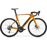 Merida Reacto 4000 aero road bike in gold and black, side view on a white background