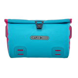 Cyber blue rectangular Ortlieb Velo-Sling 3L handlebar bag with black buckle closure and pink side accents.