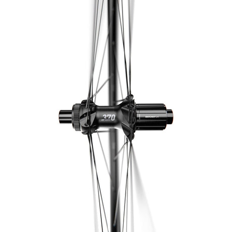 Close-up view of a bicycle wheel hub, showing its spokes and the central hub mechanism. The black DT Swiss hub on the A 1800 SPLINE disc brake wheel, clincher 30 x 20 mm, front is connected to thin spokes radiating outward. The background is completely white, highlighting the sleek design of the hub.