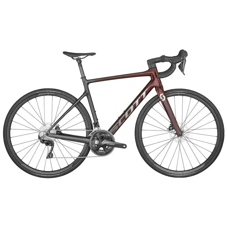 The Addict 30 Red Road Bike by Scott features a sleek dark maroon and black frame with drop handlebars, thin tires, and disc brakes. The branding prominently reads "Scott" on the frame, and the bike's saddle is positioned for an aerodynamic riding posture.